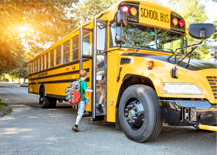 student getting on bus